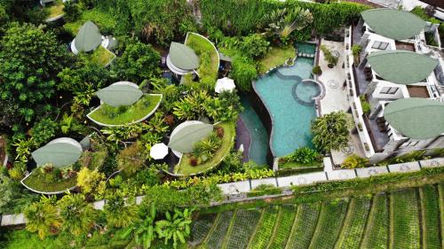 an aerial view of a resort with a pool at De Moksha Eco Friendly Boutique Resort in Tabanan