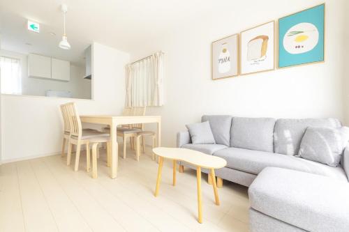 a living room with a couch and a table at Near Shinjuku 3 stops in Tokyo