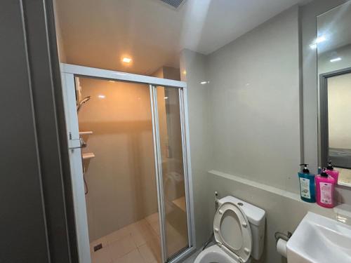 a bathroom with a shower and a toilet and a sink at The Base Central Pattaya by Leya in Pattaya Central