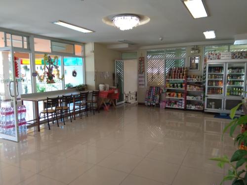 a room with a table and chairs in a store at ฐิติกร แกรนด์วิว in Thanya Buri