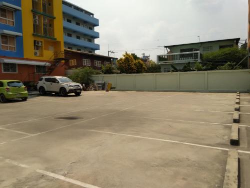 a parking lot with two cars parked in it at ฐิติกร แกรนด์วิว in Thanya Buri