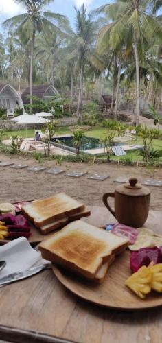 a table with two plates of bread on top of it at La Royale Nusa Penida in Nusa Penida