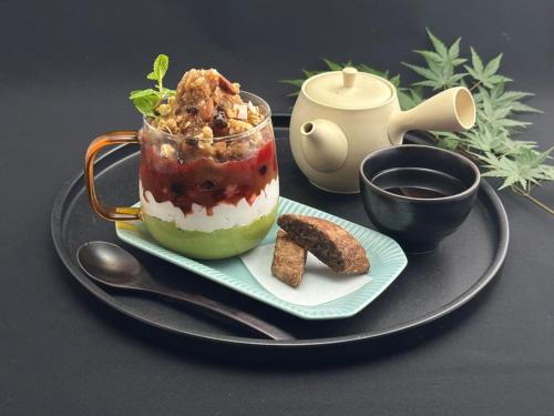 a dessert in a glass jar on a plate with a plateasteryasteryasteryastery at hotel tou nishinotoin kyoto in Kyoto