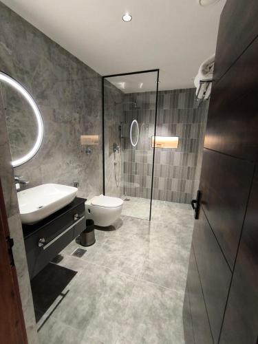 a bathroom with a sink and a toilet and a shower at Ayana Resorts in Hyderabad