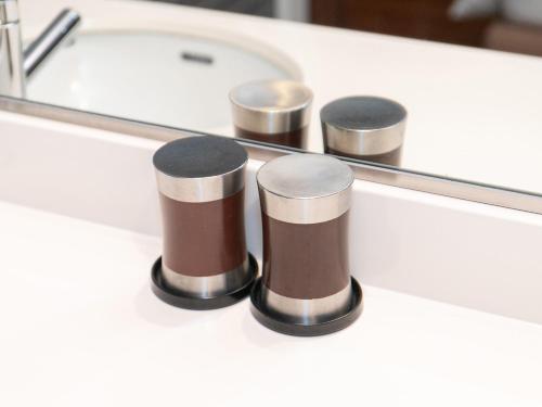 a bathroom counter with a sink and a mirror at Sutton Hotel Hakata City in Fukuoka