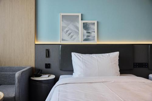 a bedroom with a bed and two pictures on the wall at Country Inn&Suites By Radisson, Xi'an Bell and Drum Tower Flagship in Xi'an