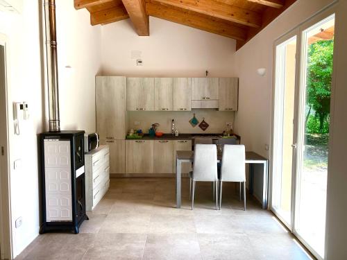 a kitchen with a table and chairs in a room at My House in Monsampietro Morico