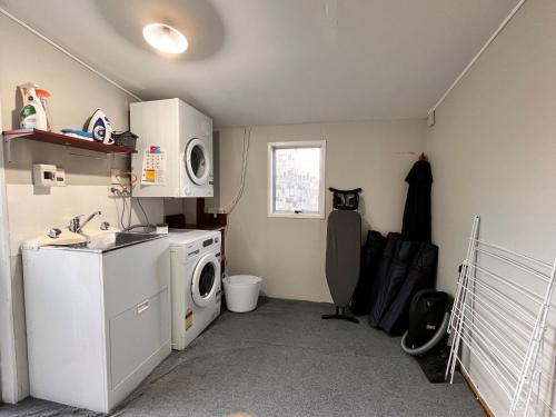 a laundry room with a washer and a washing machine at Smithy's - Lake Tekapo in Lake Tekapo