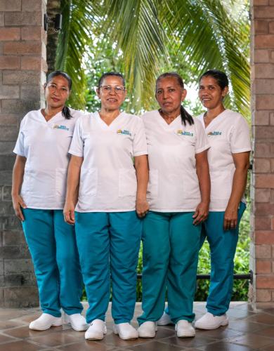 a group of men and women in white shirts and blue pants at Hostería Horizontes in Caucasia