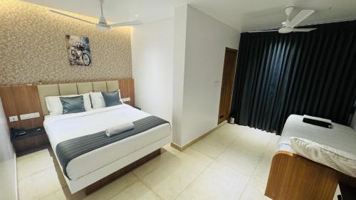 Ένα ή περισσότερα κρεβάτια σε δωμάτιο στο Vaigai Residency