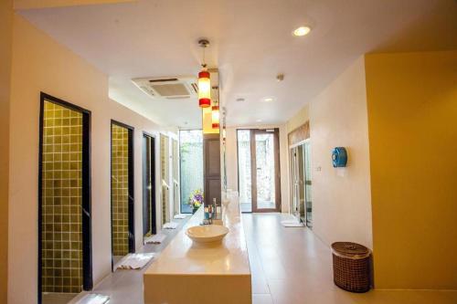a bathroom with a sink in the middle of a room at Phi Phi Banyan Villa in Phi Phi Don