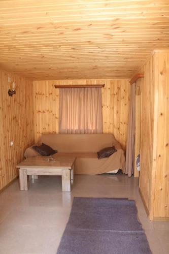 a room with a bed and a table in a cabin at Katie in Tianeti in Zhebota