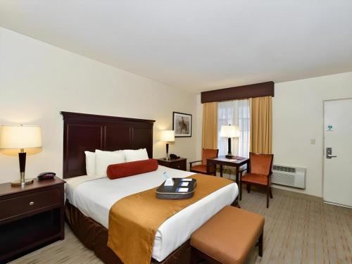 a hotel room with a large bed and a desk at Best Western Frontier Motel in Lone Pine