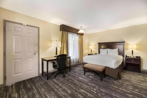 a hotel room with a bed and a desk at Best Western Frontier Motel in Lone Pine