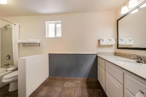 a bathroom with a sink and a toilet and a mirror at Best Western Frontier Motel in Lone Pine