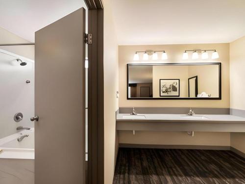 a bathroom with two sinks and a large mirror at Best Western Frontier Motel in Lone Pine