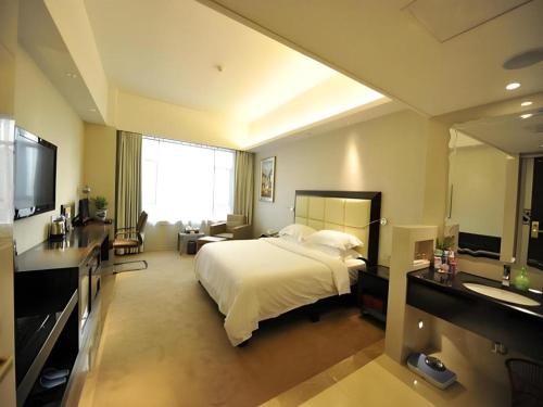 a hotel room with a bed and a bathroom at Fuzhou Xin Zi Yang Hotel in Fuzhou