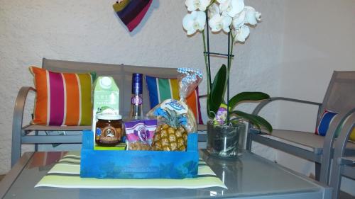 a table with a basket of food and drinks on it at Vivenda Atlântida in Ponta Delgada