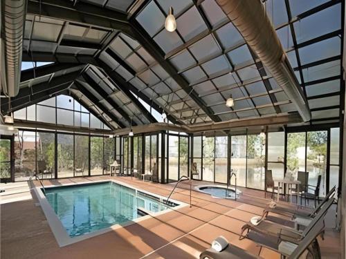 an indoor swimming pool with a large glass ceiling at Staybridge Suites Newport News in Newport News