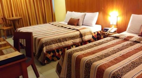 Ένα ή περισσότερα κρεβάτια σε δωμάτιο στο Hotel Asuncion
