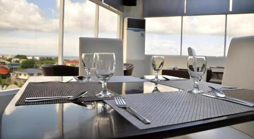 a dining table with wine glasses and silverware on it at The Grande Suites in Surigao
