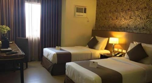 Кровать или кровати в номере GT Hotel Bacolod