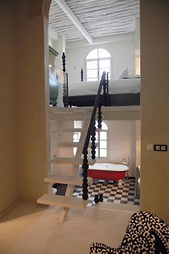 a room with two bunk beds and a bath tub at L'Alcazar in Rabat