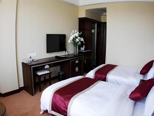 Dunhuang Dunhe Hotelにあるベッド
