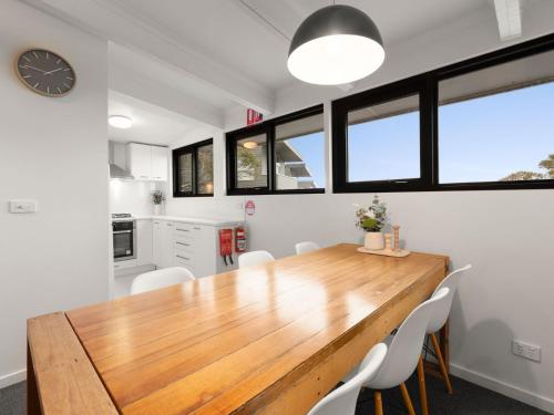a kitchen and dining room with a wooden table and chairs at SKI View 4 in Mount Buller