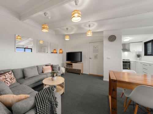 a living room with a couch and a table at SKI View 4 in Mount Buller
