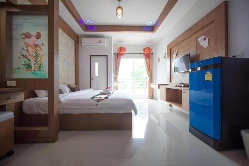 a bedroom with a bed and a large window at The Linux Garden Hotel (City Amphur Muang Yala) in Yala