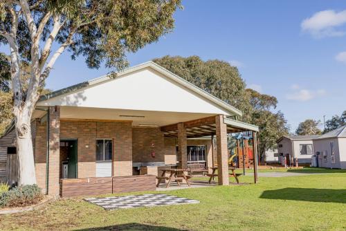 a house with a pavilion in a yard at Ocean Grove Holiday Park in Ocean Grove
