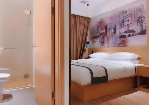 a bedroom with a large bed and a bathroom at City Comfort Inn Shenzhen Exhibition Center North Huaqiang Metro Station in Shenzhen