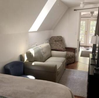 a bedroom with a couch and a chair and a bed at Charming Guest House! in Exeter