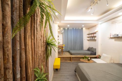 a bedroom with a wooden wall with a plant at Homestay Nhacuabu in Hanoi
