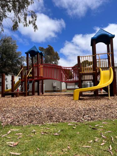 a playground with two slides in a park at Ocean Grove Holiday Park in Ocean Grove