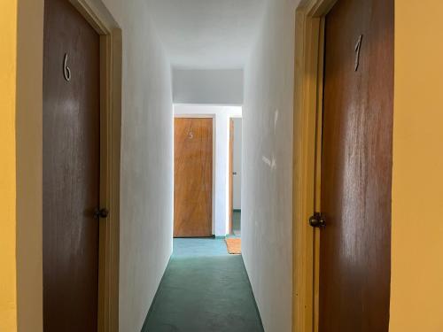an empty hallway with two doors and a hallway with a hallway at African Symbol Guest House in Montego Bay