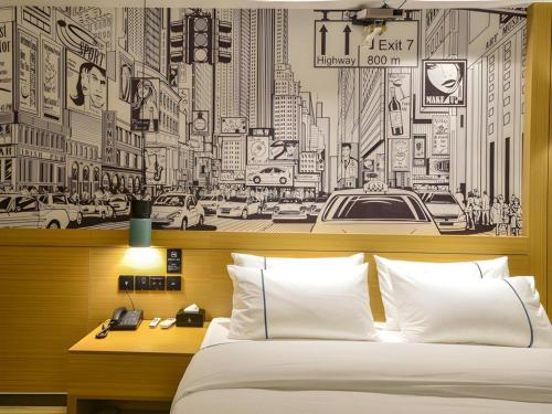 a bedroom with a black and white drawing of a city at City Comfort Inn Lichuan Railway Station Jimi Home in Enshi