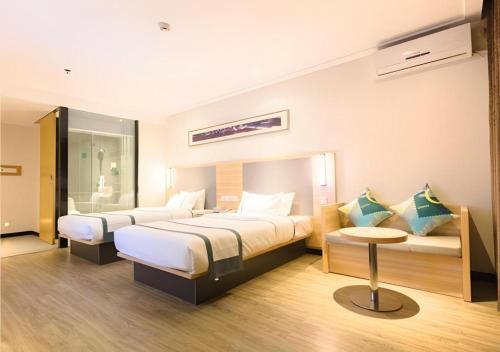 Postel nebo postele na pokoji v ubytování City Comfort Inn Guigang Zhongshan High Speed Railway Station