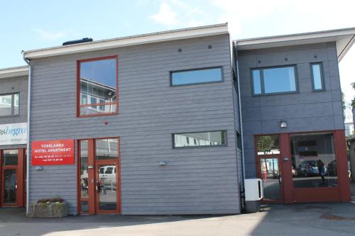 a gray building with red doors and windows at Hotel Torslanda in Torslanda
