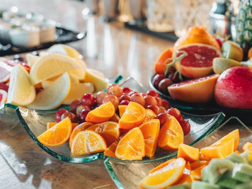 a bunch of fruits on plates on a table at GINZA HOTEL by GRANBELL in Tokyo