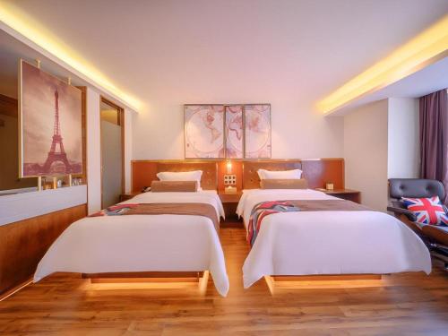 a room with four beds in it with the eiffel tower at James Joyce Coffetel Wuhan Gutian Er Road Metro Station in Wuhan