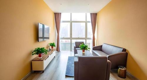 a living room with a couch and a table at Thank Inn Hotel Tianjing Jinnan University in Tianjin