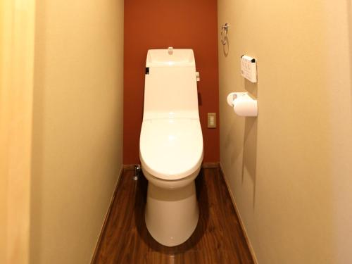 a bathroom with a white toilet in a stall at 京一軒町家 さと居 鉄仙 SATOI TESSEN Omiya-Gojo in Kyoto