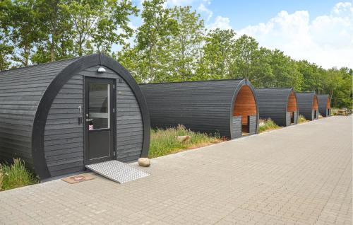 a row of black domed houses with a door at Nice Apartment In Nørre Nebel With Wifi in Nørre Nebel