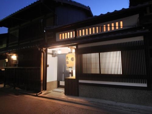 an entrance to a building at night with lights at 京一軒町家 さと居 鉄仙 SATOI TESSEN Omiya-Gojo in Kyoto