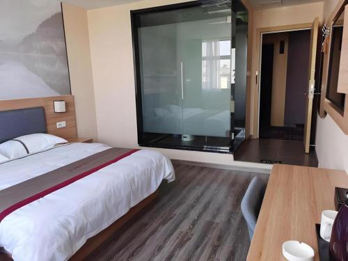 a bedroom with a large bed and a large window at Thank Inn Hotel Jiangsu Wuxi High-Tech Zone Ruigang Pedestrian Street in Wuxi