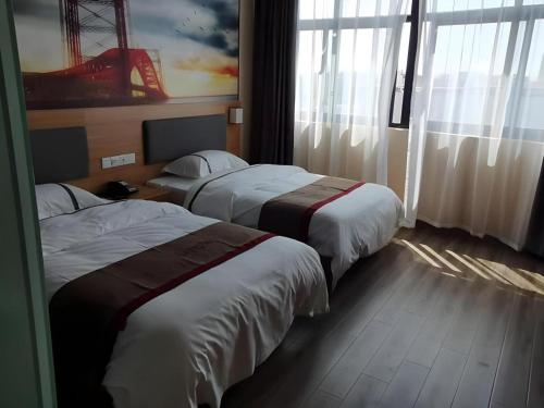 a hotel room with two beds and a window at Thank Inn Hotel Jiangsu Wuxi High-Tech Zone Ruigang Pedestrian Street in Wuxi