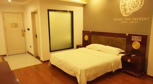 Ένα ή περισσότερα κρεβάτια σε δωμάτιο στο Shell Hotel Liaocheng Dongchang Xi Road Railway Station