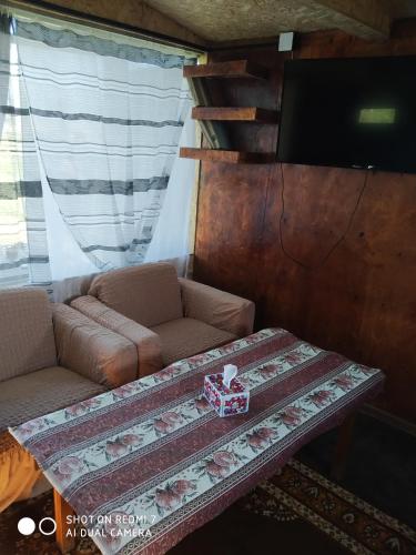 a living room with a couch and a table at Honey home in Chʼkalovka